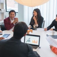asian team in a meeting discussing european prospects 