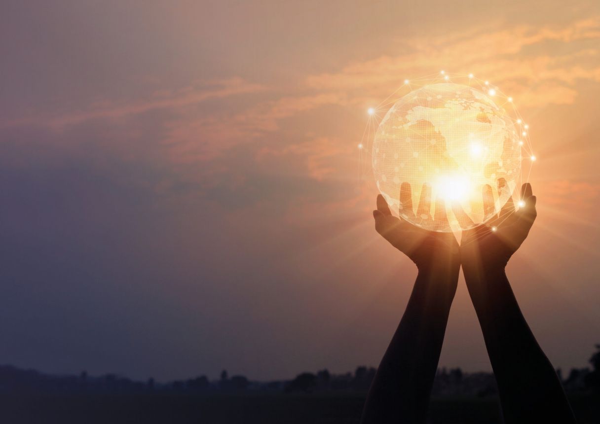 Hands holding glowing earth