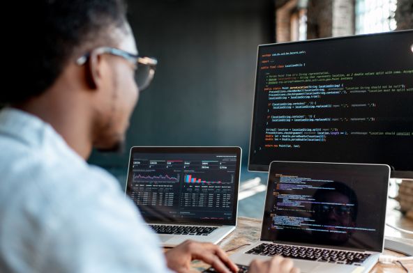 Young Black male programmer writing code