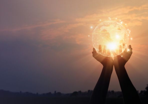 Hands holding glowing earth