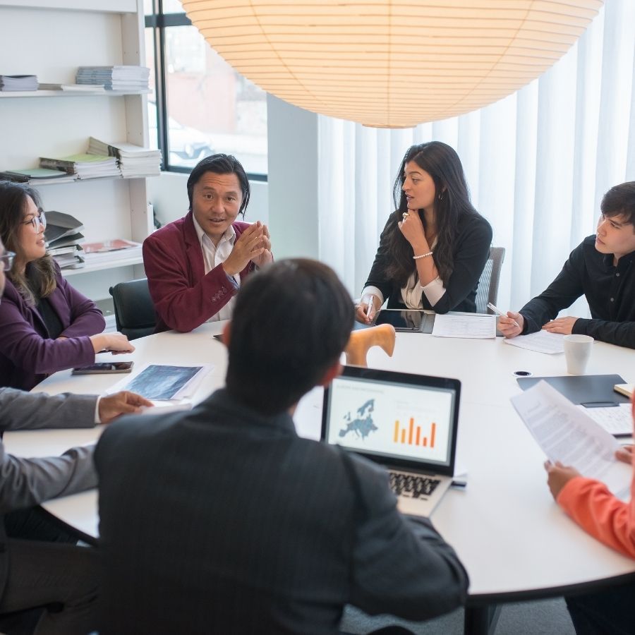 a team sitting around a table in an office