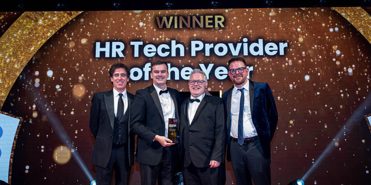 a group photo of Mauve receiving its 'HR Tech Provider of the Year' winner's trophy on stage at the Personnel Today Awards ceremony