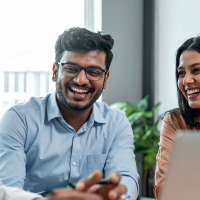 Asian male and female colleagues laughing