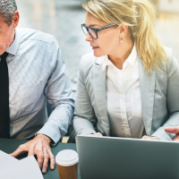 male and female colleagues discussing figures