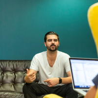 Man sat down while leading a sales meeting