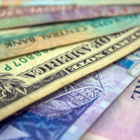 A closeup of various countries' currency notes overlapping