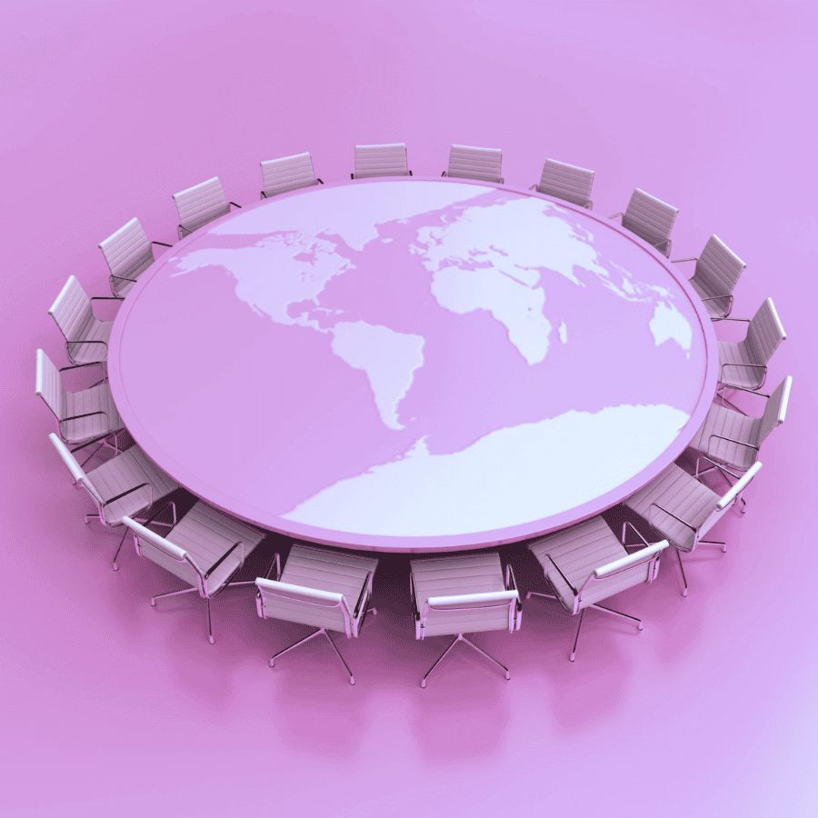 A round table with a world map, surrounded by chairs map on it