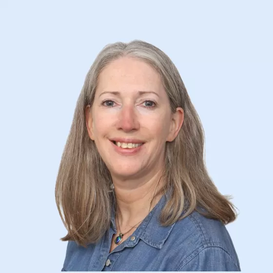 Teresa Lewis Headshot with Blue Background