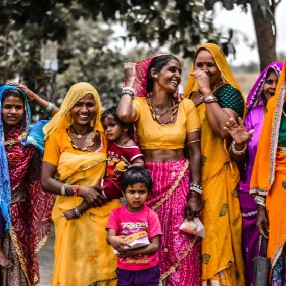 A line of Indian women and children dressed in colourful attire